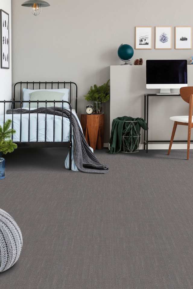 gray patterned carpet in modern kids room with twin bed and desk